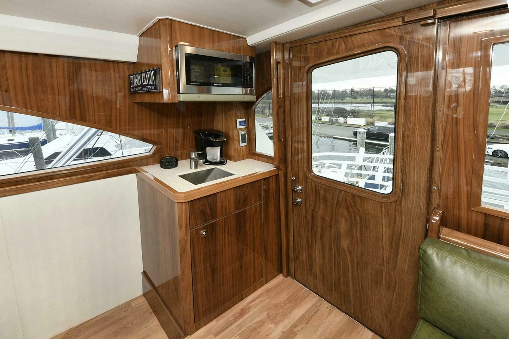 a wood paneled kitchen with a wood paneled wall aboard ON THE EDGE Yacht for Sale