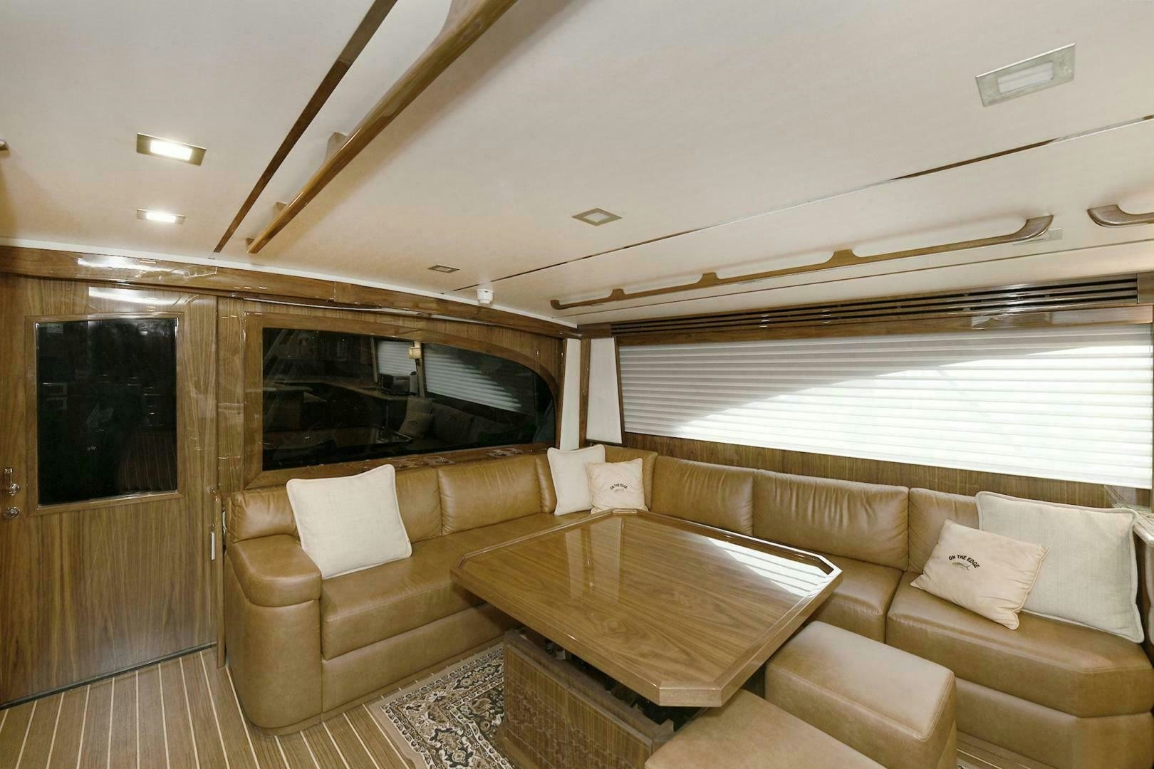 a living room with a couch and a table aboard ON THE EDGE Yacht for Sale