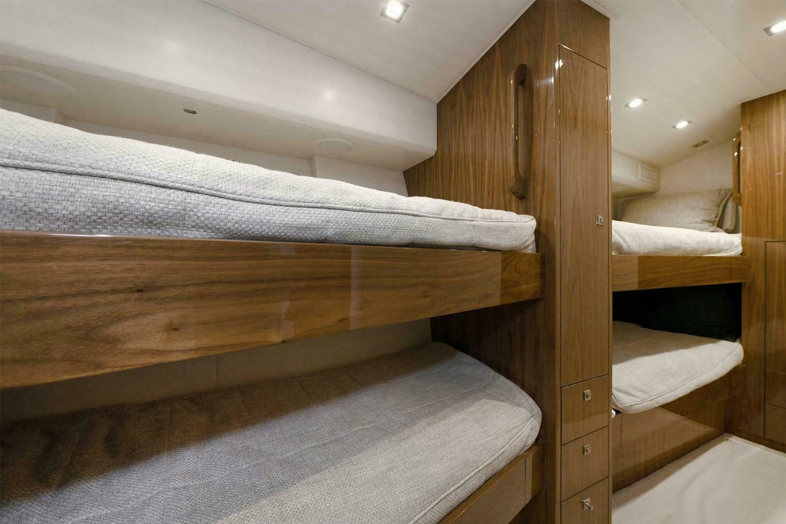 a wooden bunk bed aboard ON THE EDGE Yacht for Sale