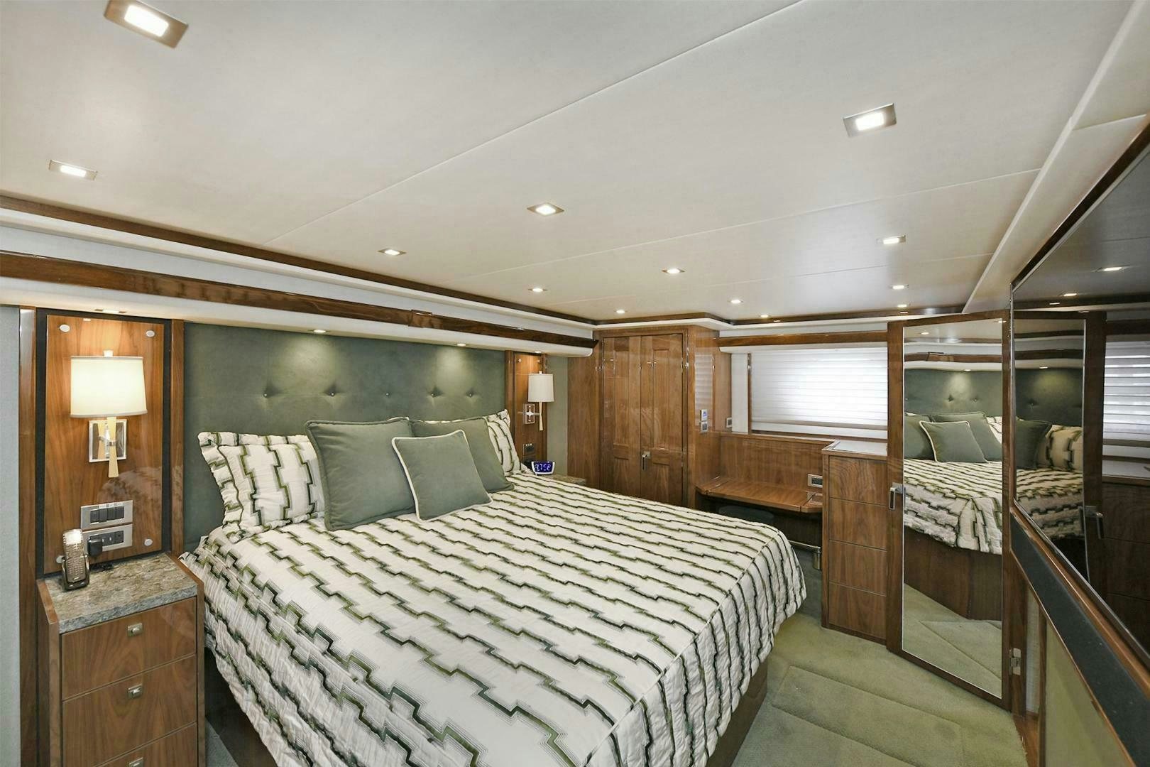 a bedroom with a bed and a mirror aboard ON THE EDGE Yacht for Sale
