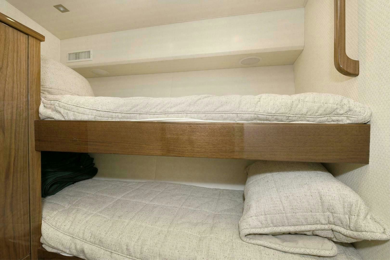 a bed with white sheets aboard ON THE EDGE Yacht for Sale