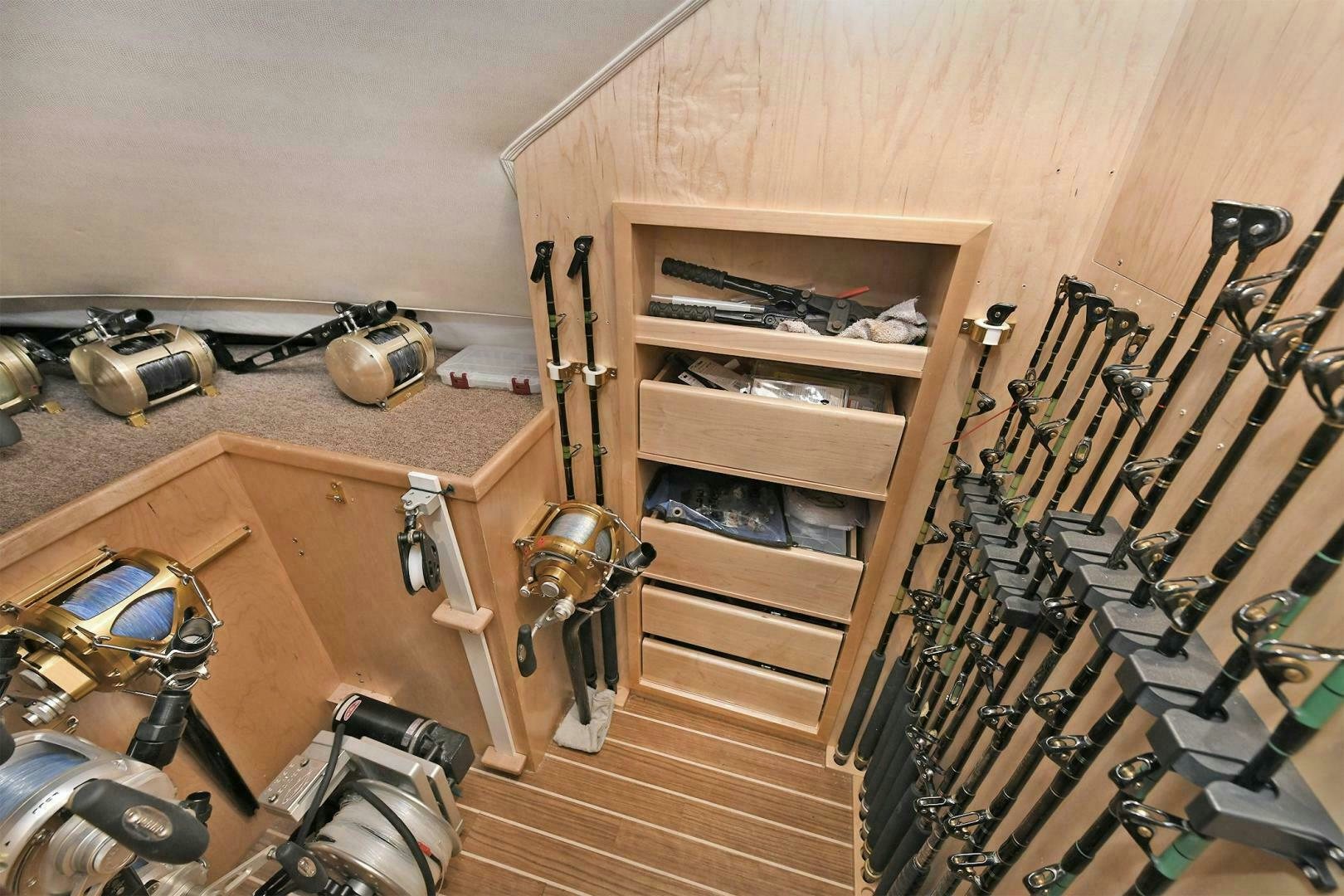 a room with a wood cabinet and tools aboard ON THE EDGE Yacht for Sale