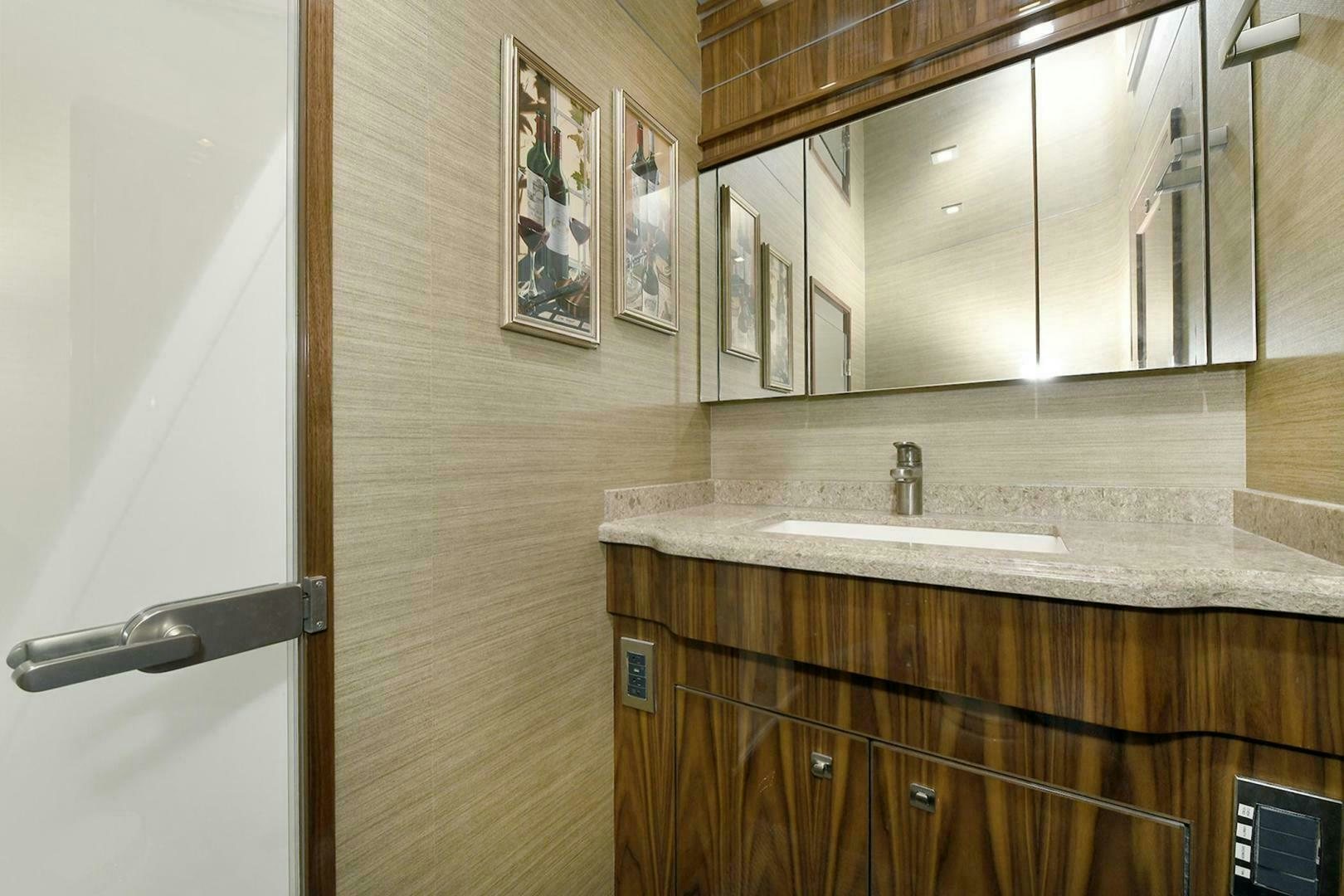 a bathroom with a sink and cabinets aboard ON THE EDGE Yacht for Sale