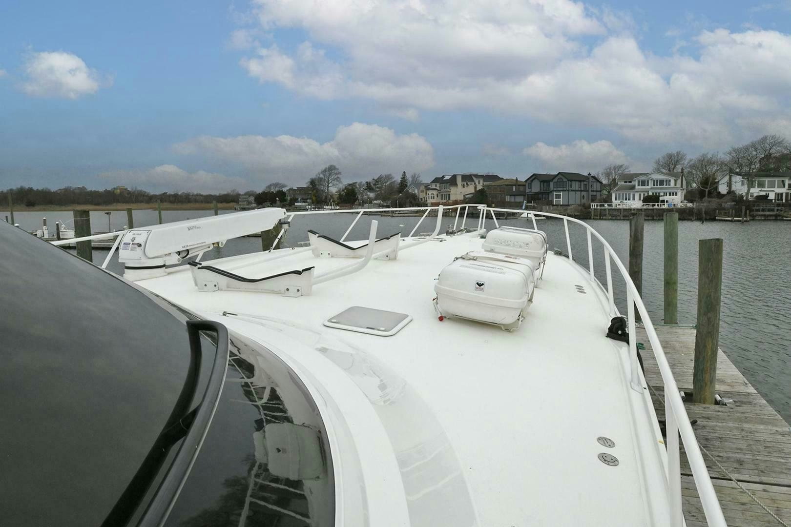 a white boat on a dock aboard ON THE EDGE Yacht for Sale