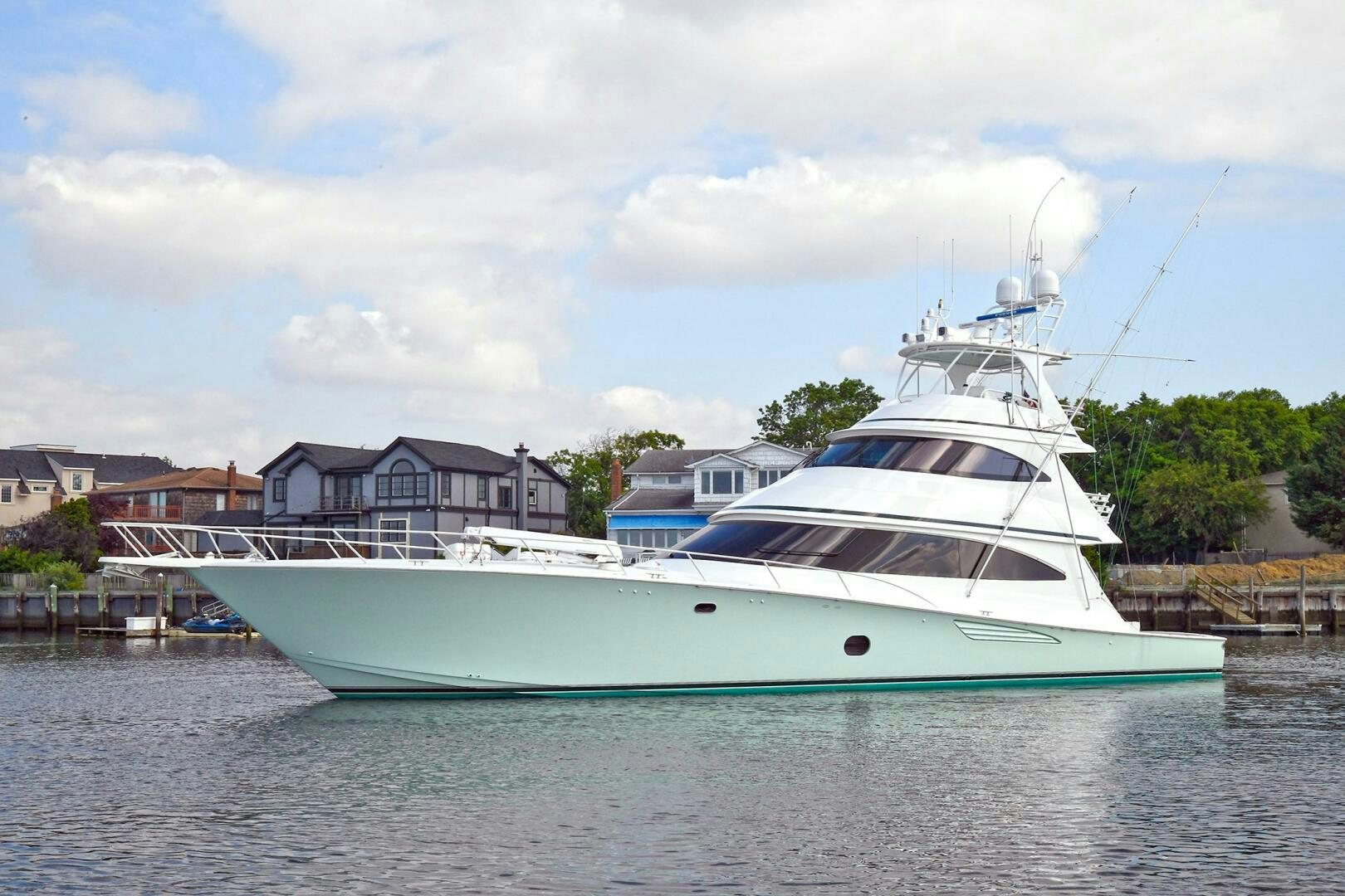 a large white boat in a harbor aboard OVER THE EDGE Yacht for Sale