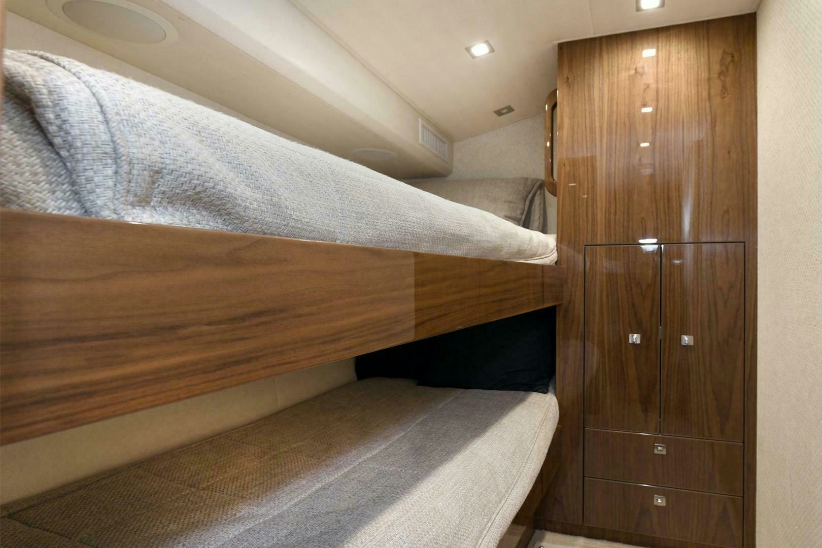 a bed with a wooden frame aboard ON THE EDGE Yacht for Sale