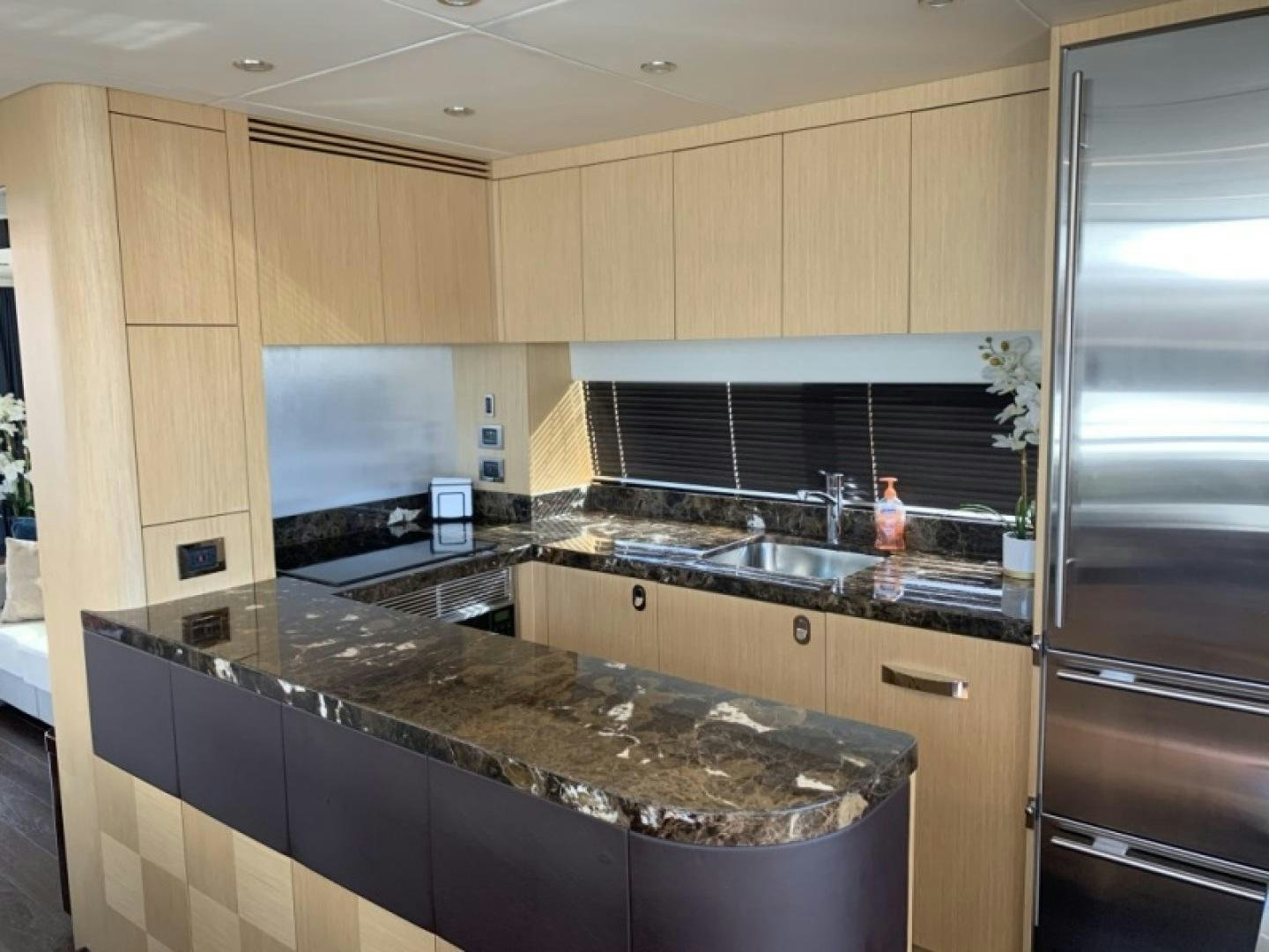 a kitchen with a marble counter top aboard NBLUE Yacht for Sale