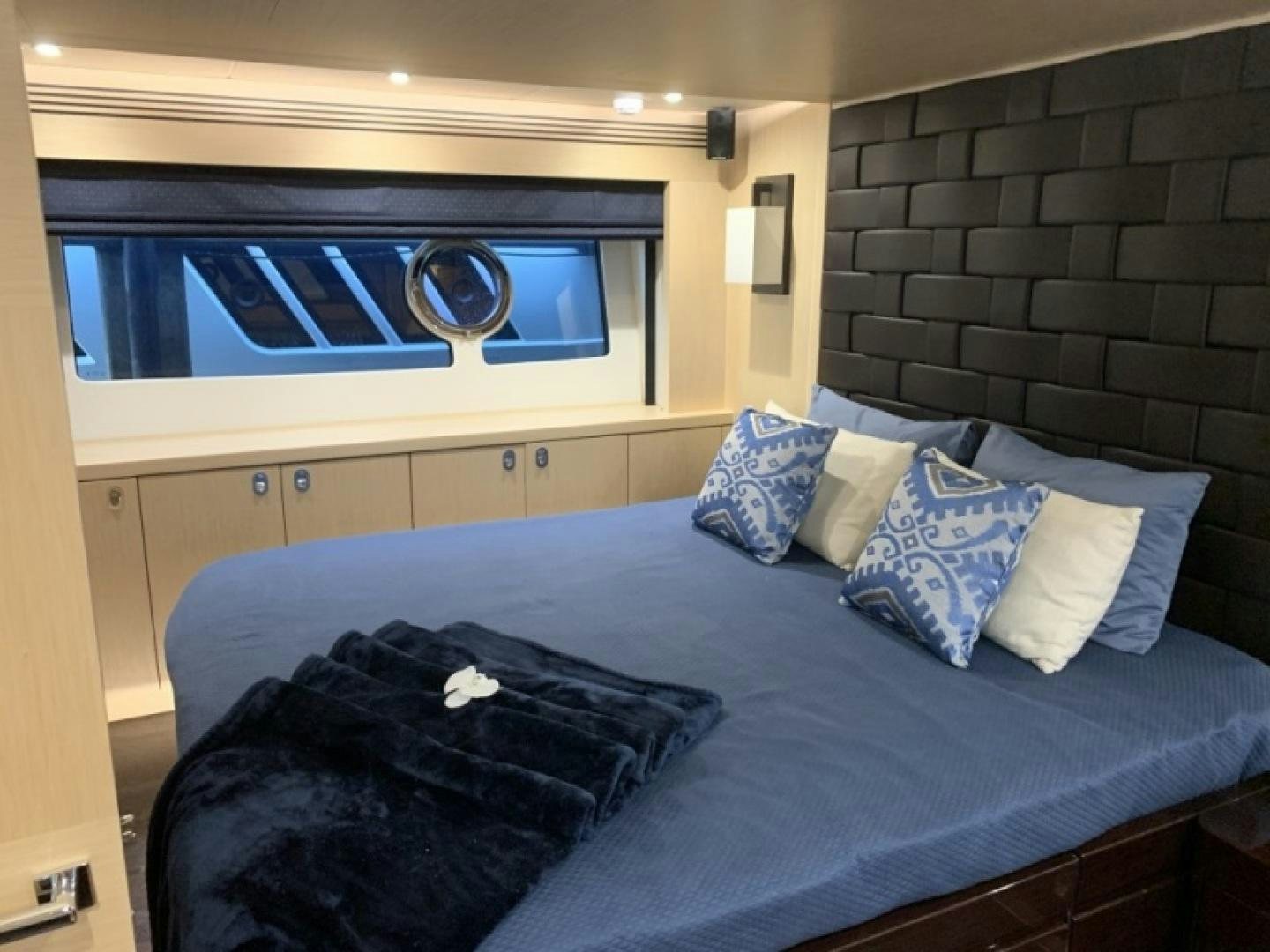 a bed with a blue blanket aboard NBLUE Yacht for Sale