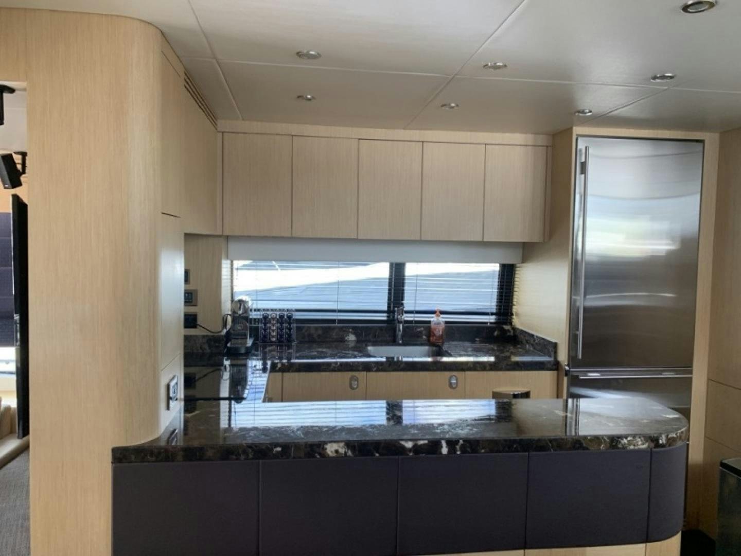 a kitchen with a large glass window aboard NBLUE Yacht for Sale
