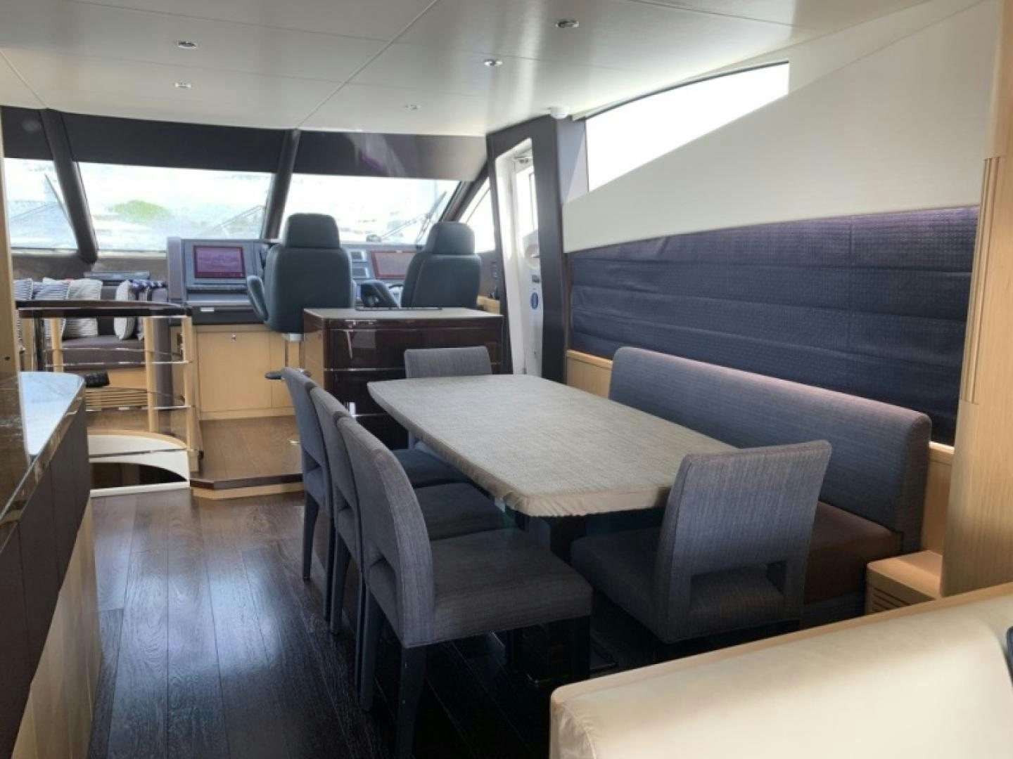 a room with a table and chairs aboard NBLUE Yacht for Sale