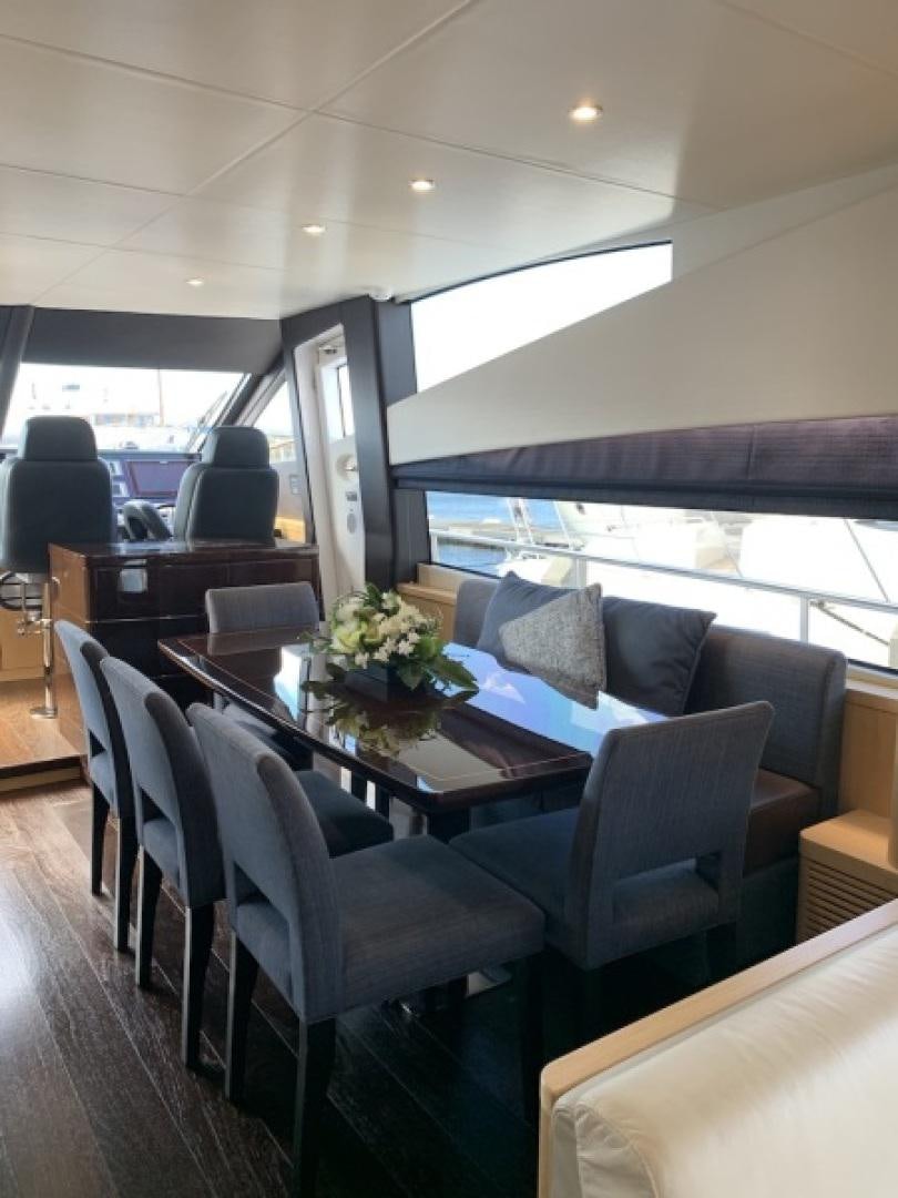 a room with a table and chairs aboard NBLUE Yacht for Sale