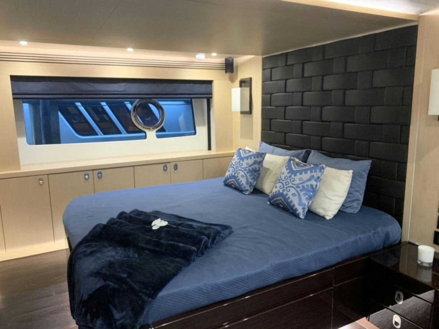 a bed with a blue blanket aboard NBLUE Yacht for Sale