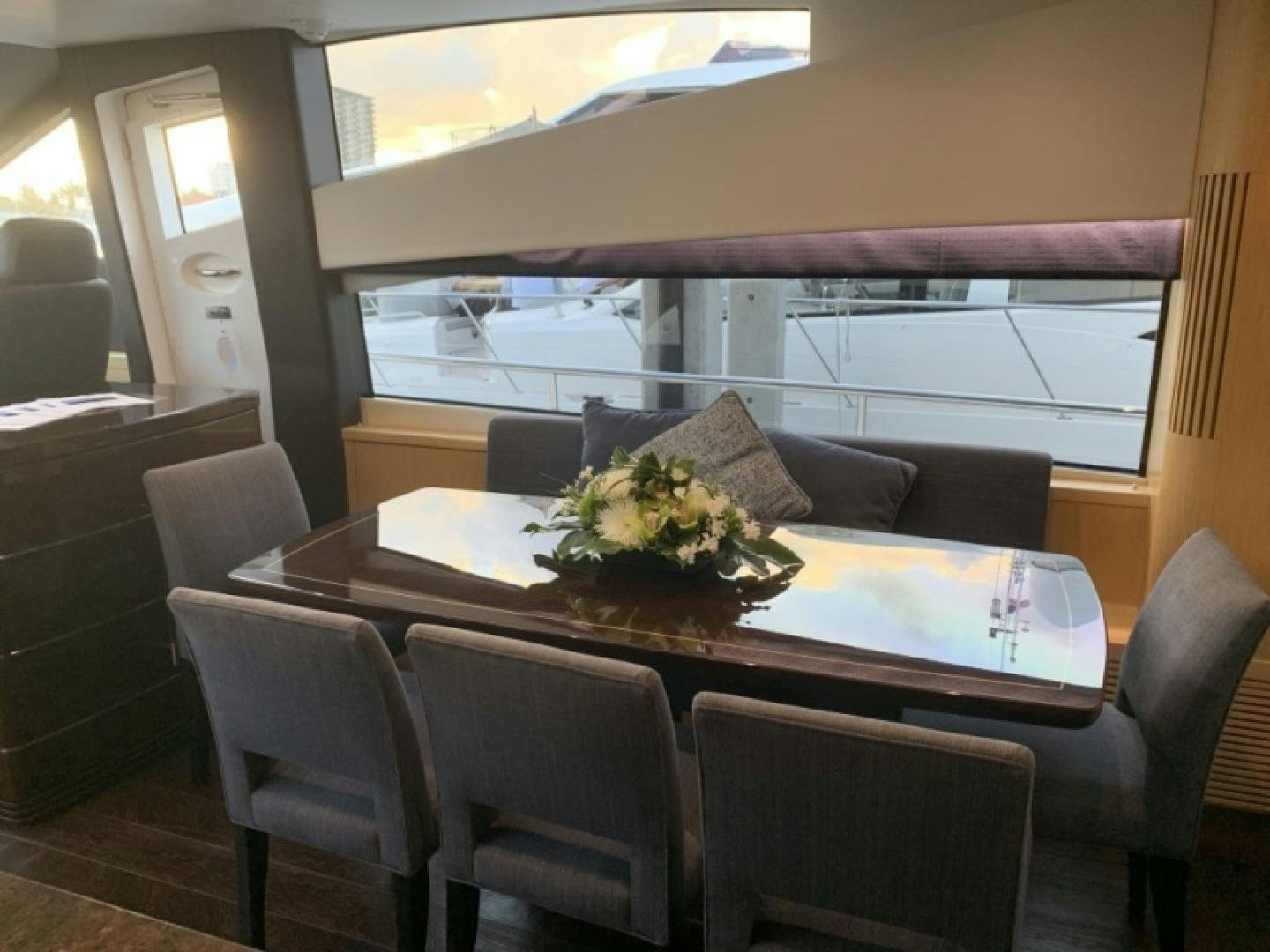 a table with chairs and a couch aboard NBLUE Yacht for Sale