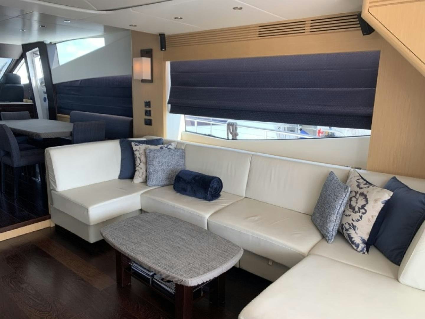 a living room with a couch and a window aboard NBLUE Yacht for Sale
