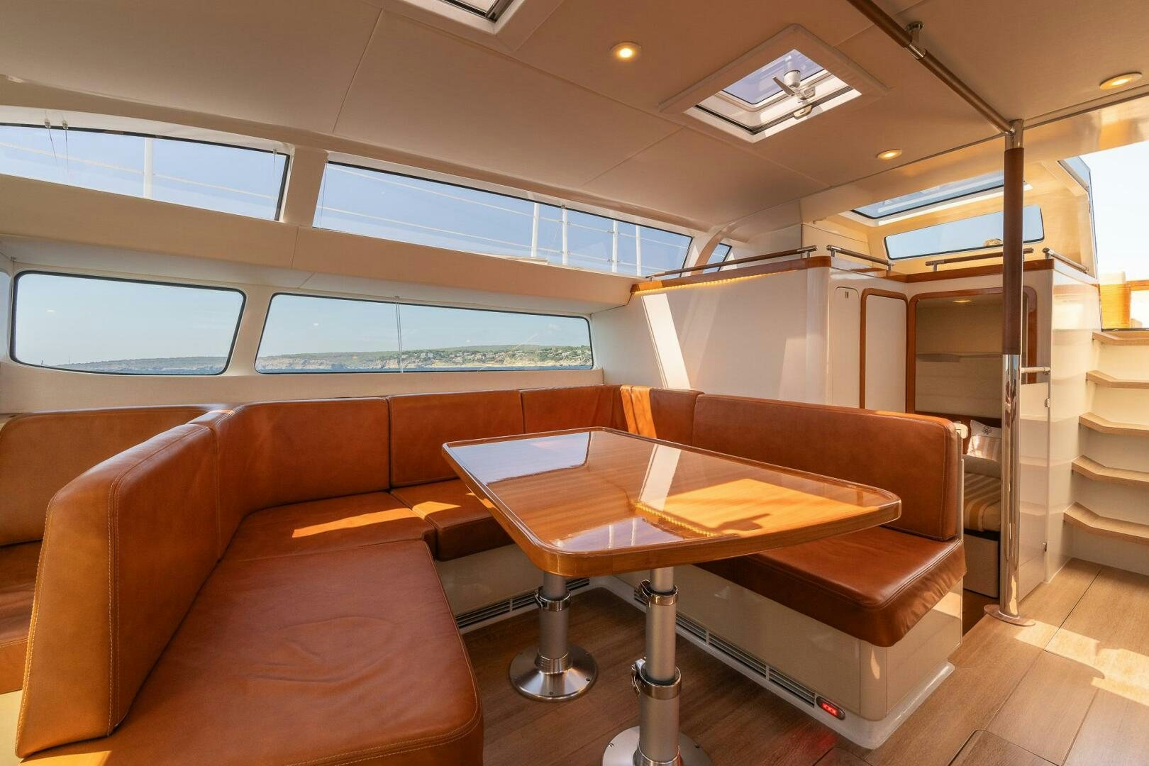 a couch and a table in a room aboard BLISS II Yacht for Sale
