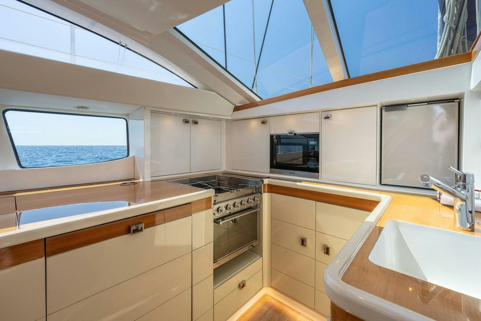 a kitchen with white cabinets aboard BLISS II Yacht for Sale