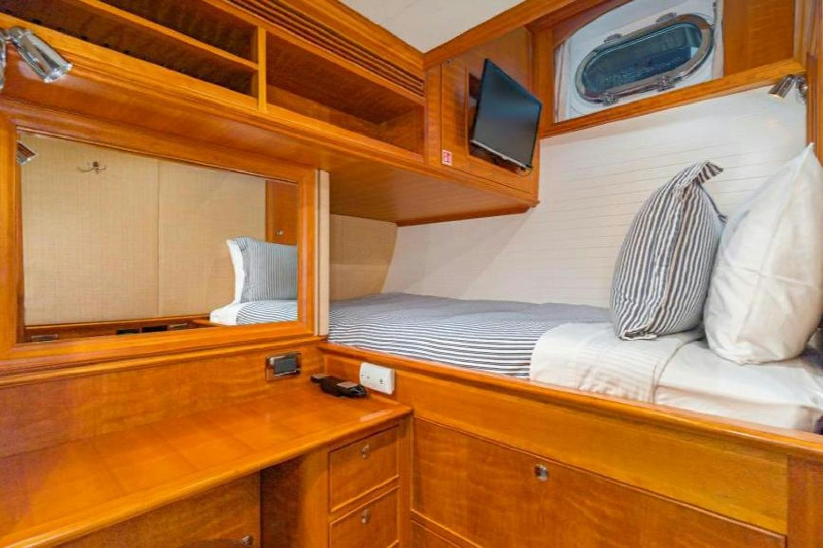 a bed with a television on top of it aboard PALIADOR Yacht for Sale