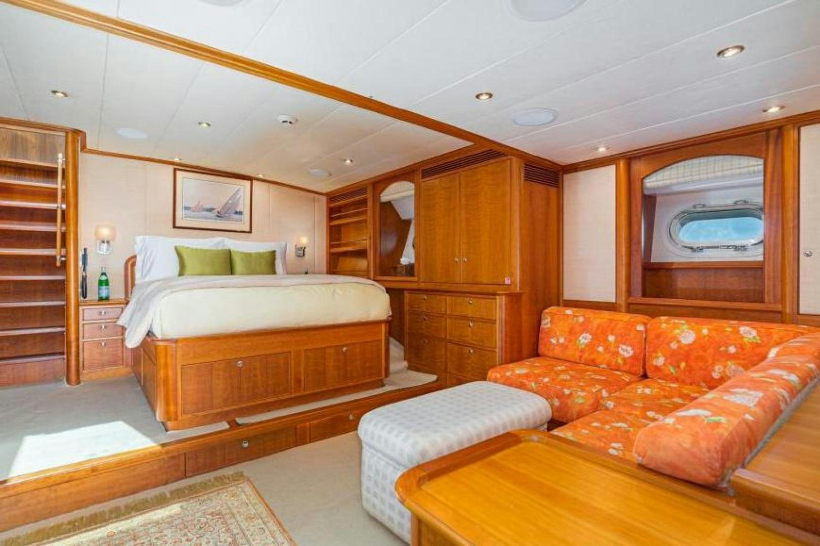a bedroom with a bed and a couch aboard PALIADOR Yacht for Sale