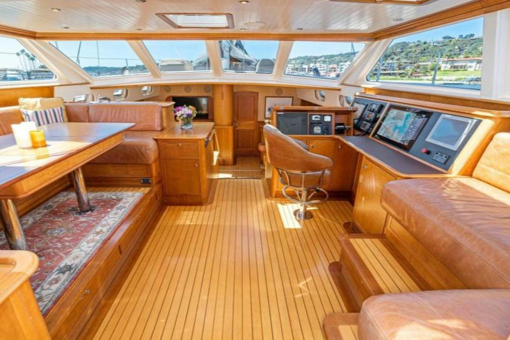 a room with a table chairs and a tv aboard PALIADOR Yacht for Sale