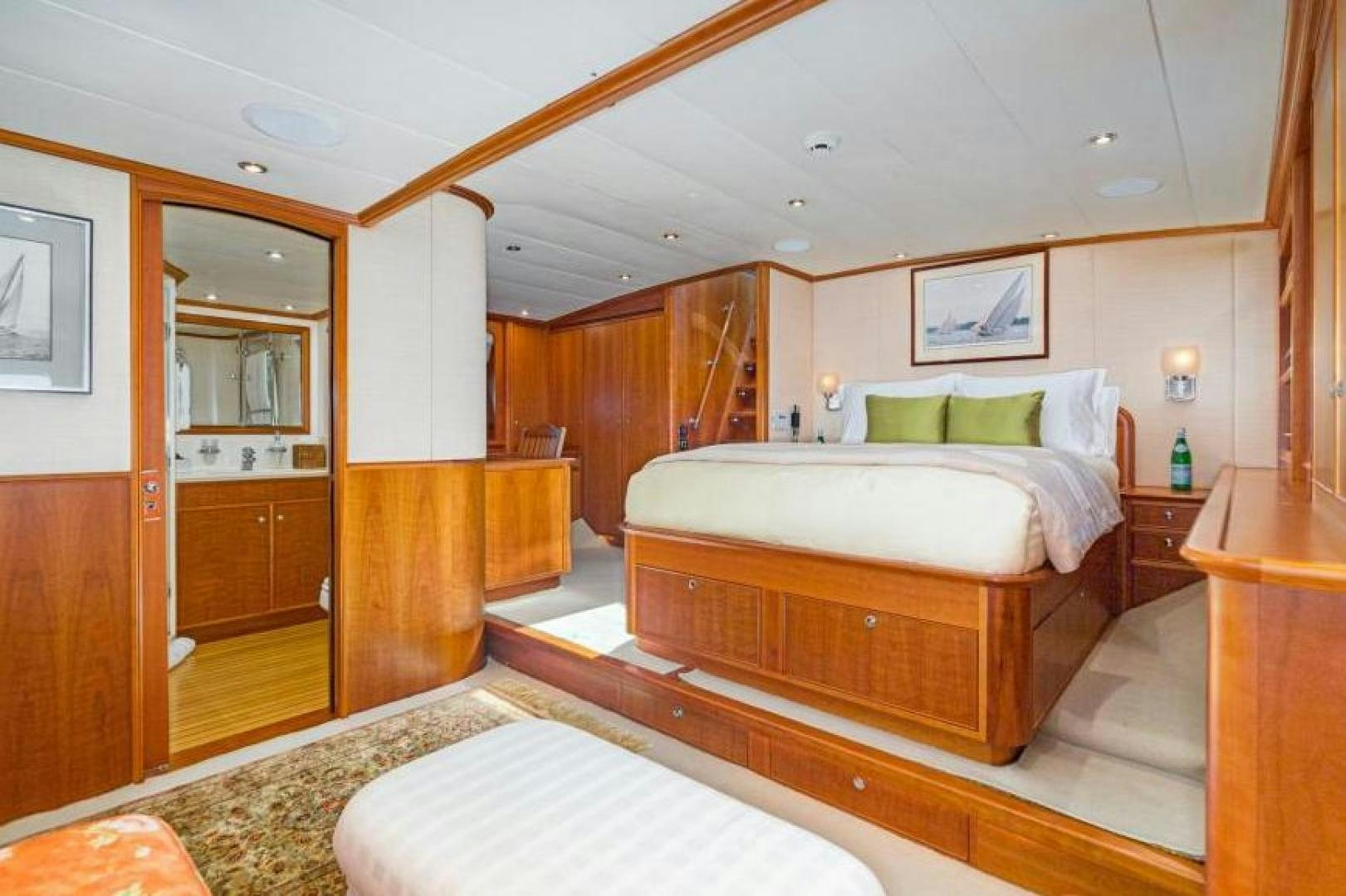 a bedroom with a bed and a mirror aboard PALIADOR Yacht for Sale