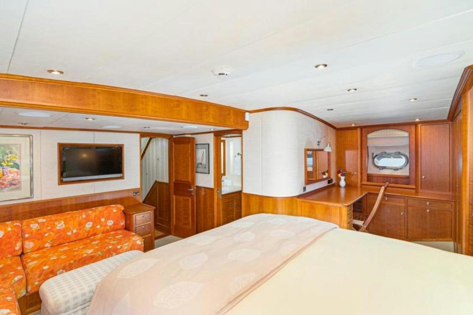 a bedroom with a bed and a television aboard PALIADOR Yacht for Sale
