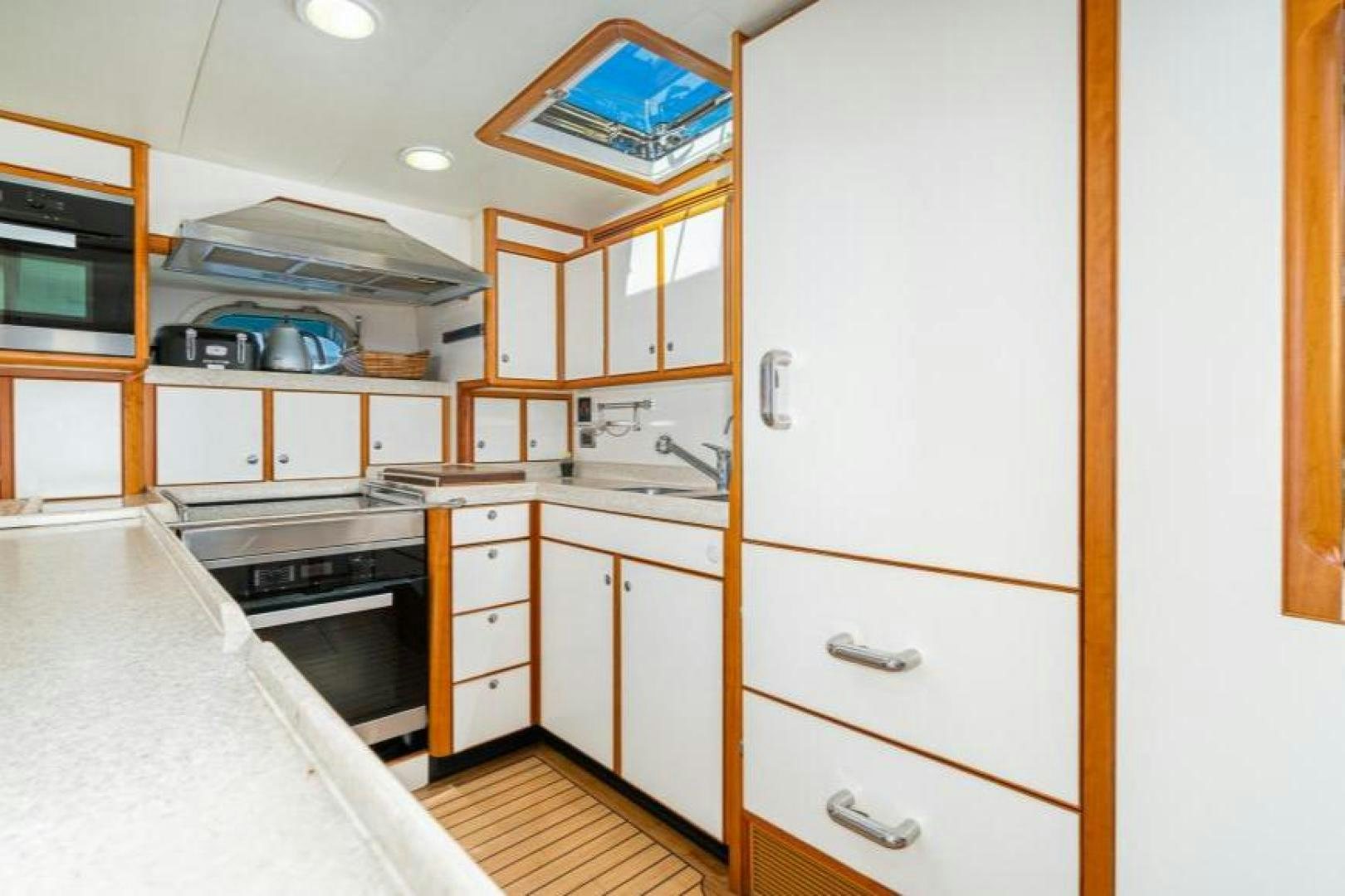 a kitchen with white cabinets aboard PALIADOR Yacht for Sale