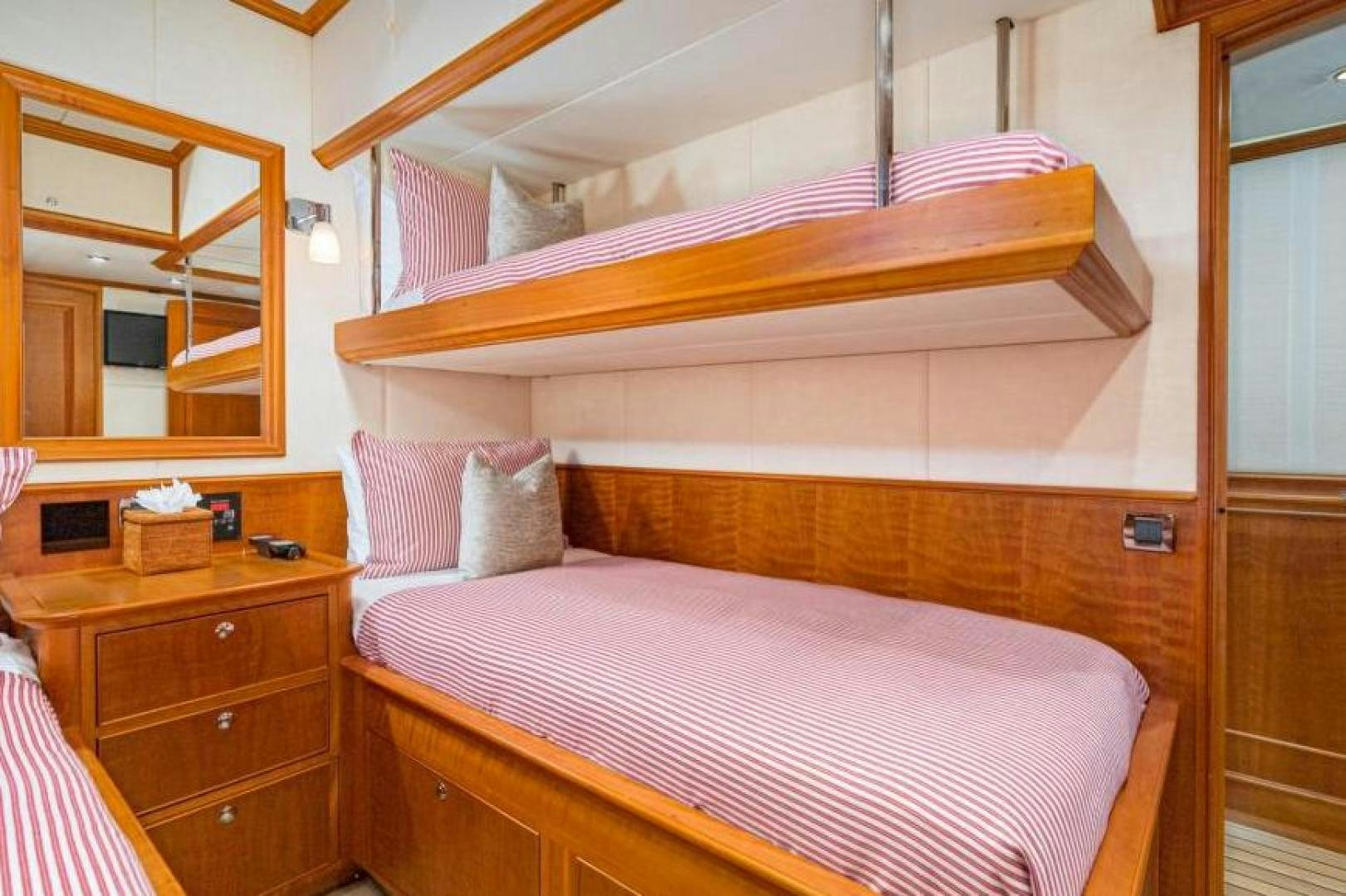 a bed with a pink comforter aboard PALIADOR Yacht for Sale