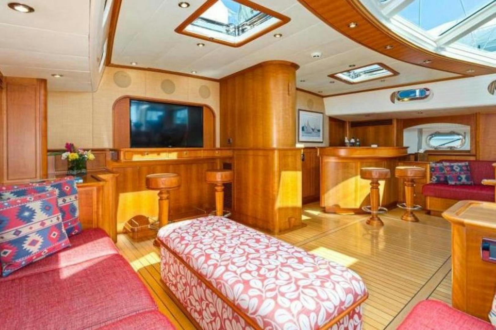 a room with a tv and couches aboard PALIADOR Yacht for Sale