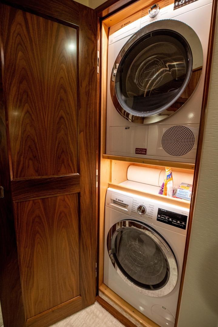 a washer and dryer in a closet aboard RAGIN CAJUN Yacht for Sale