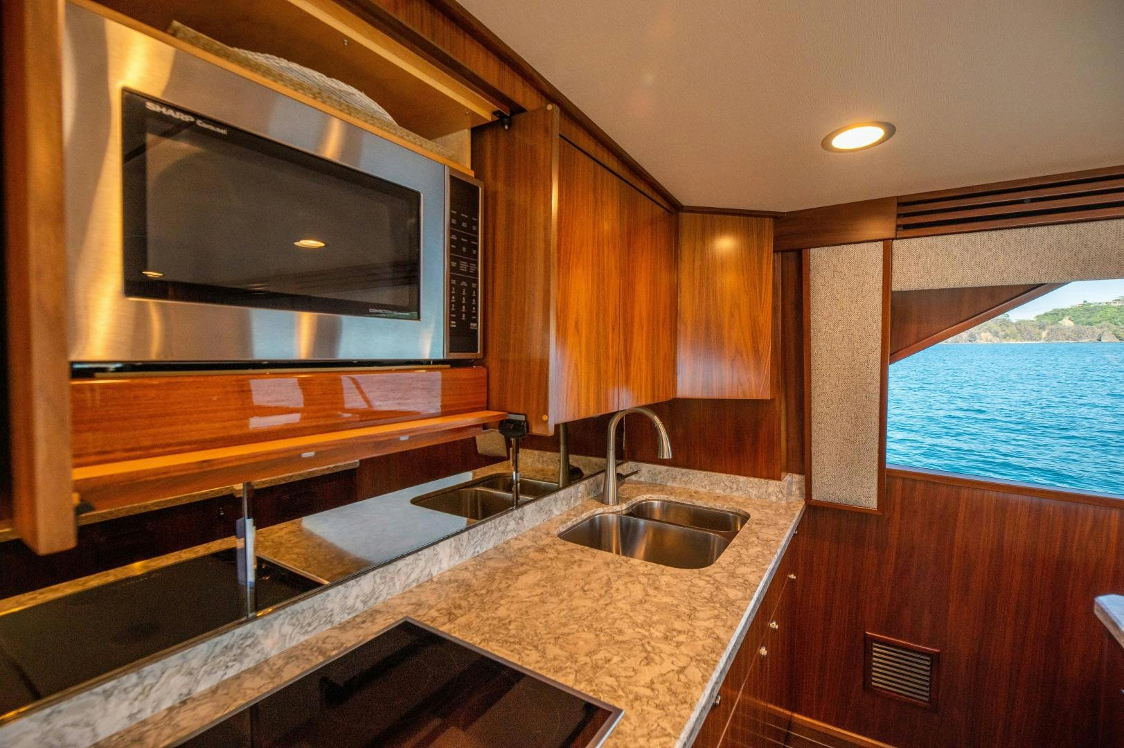 a kitchen with a large mirror aboard RAGIN CAJUN Yacht for Sale