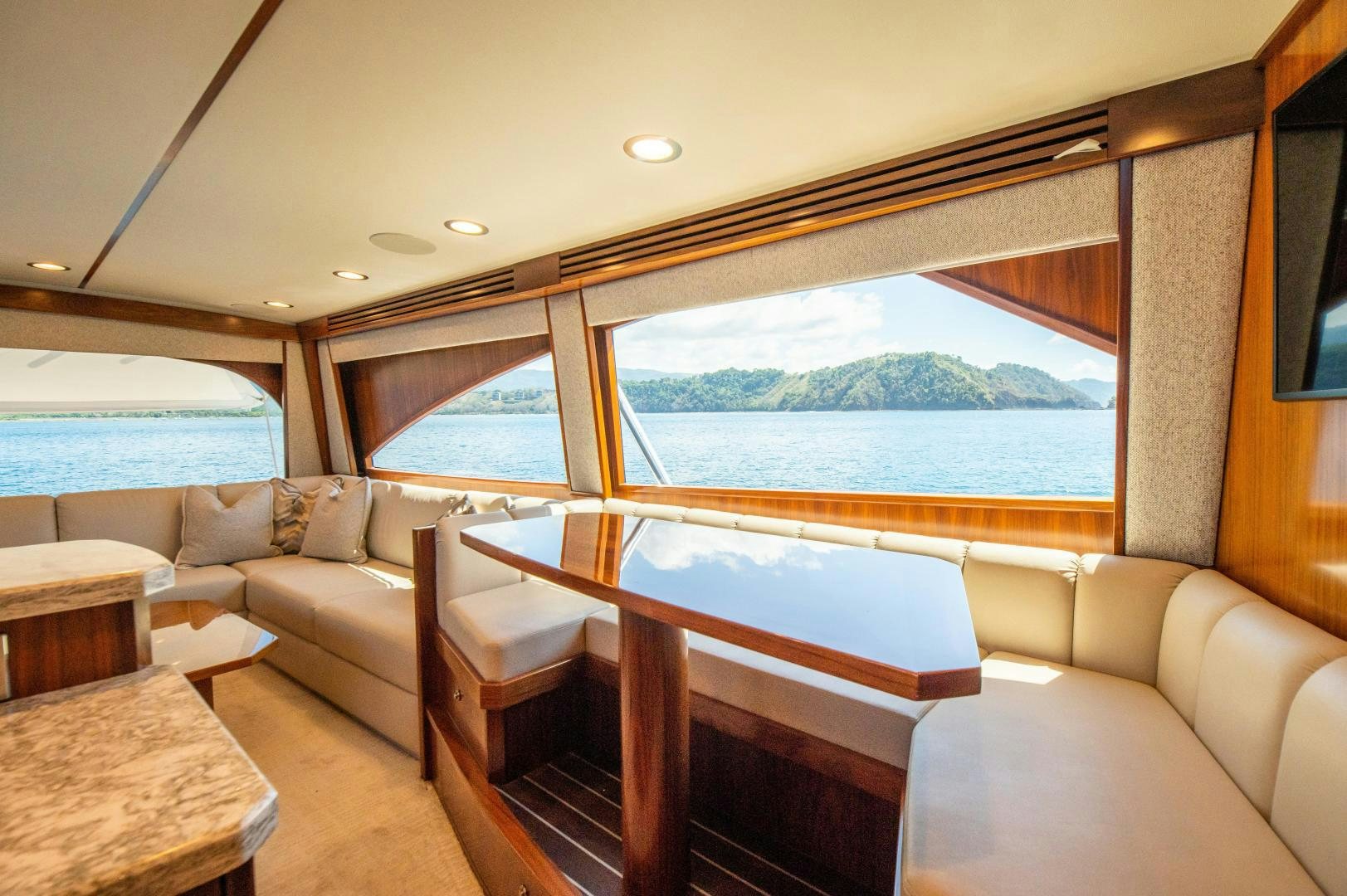 a room with a bed and a couch aboard RAGIN CAJUN Yacht for Sale