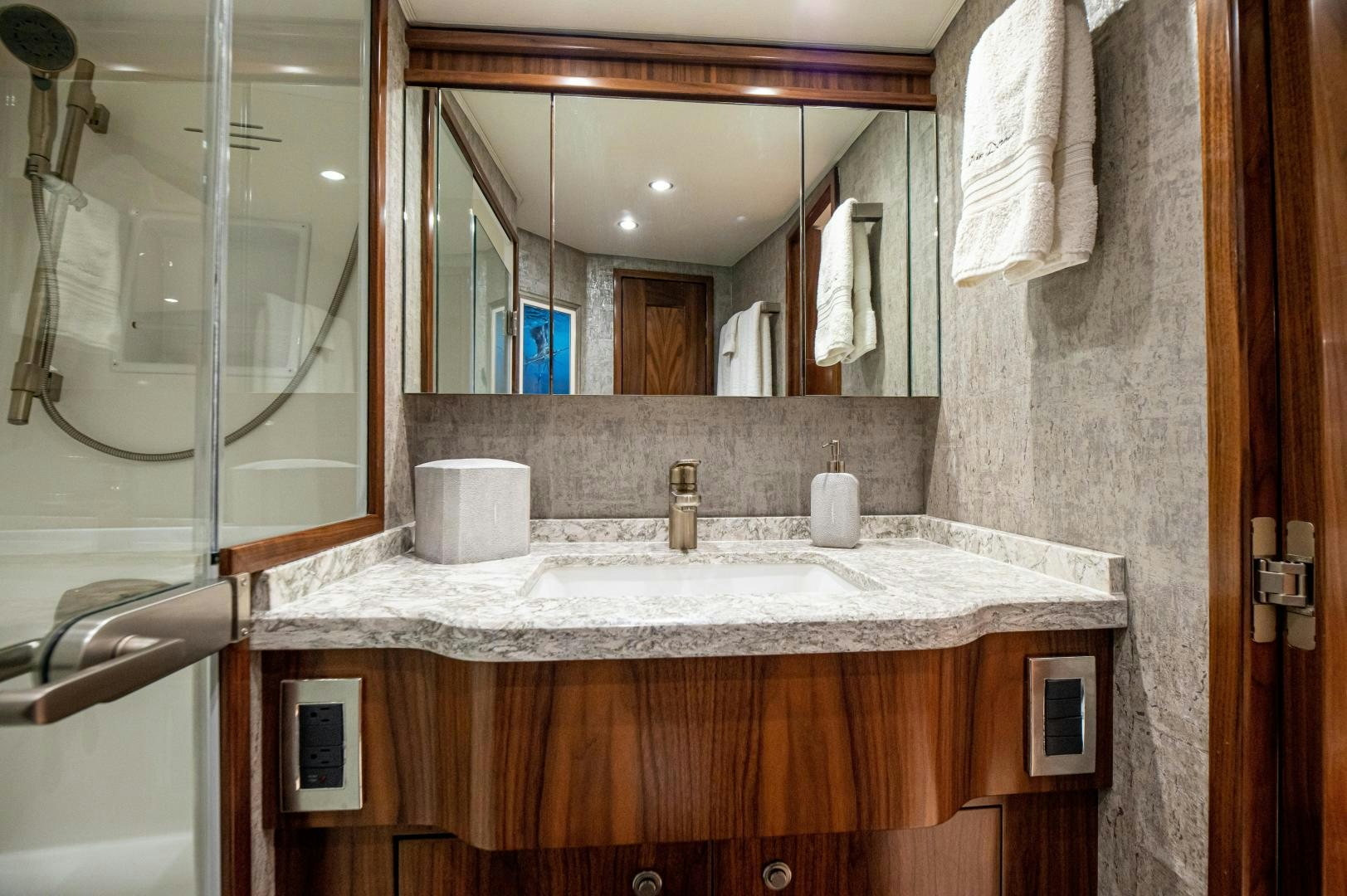 a bathroom with a large mirror aboard RAGIN CAJUN Yacht for Sale