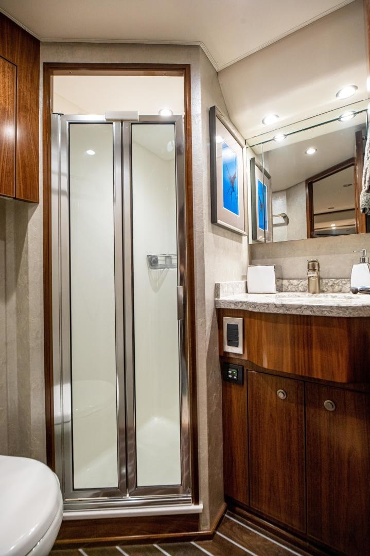 a bathroom with a glass shower aboard RAGIN CAJUN Yacht for Sale