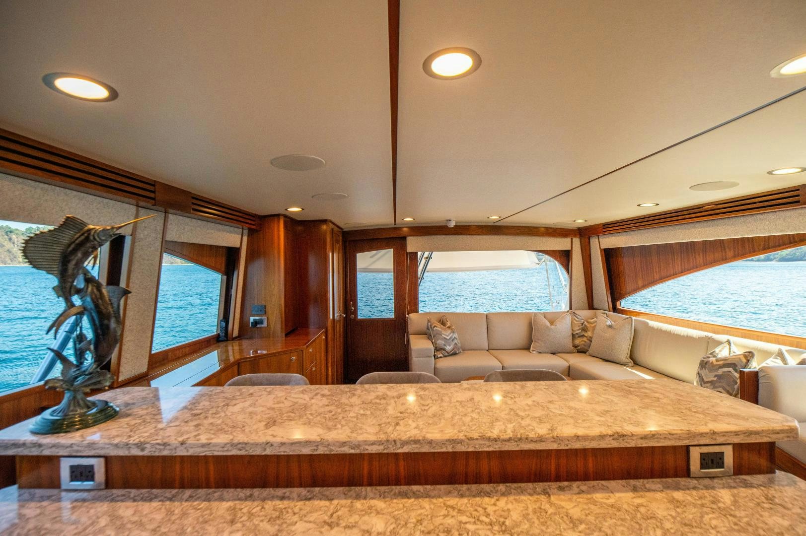 a living room with a large sofa aboard RAGIN CAJUN Yacht for Sale