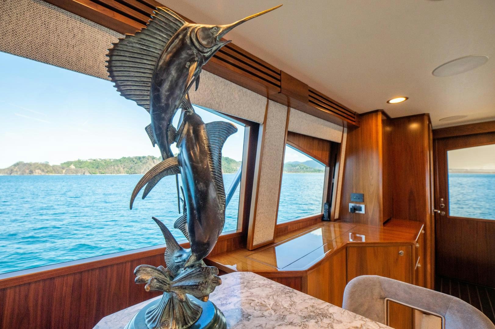 a couple of sea turtles on a table in a room with a window aboard RAGIN CAJUN Yacht for Sale