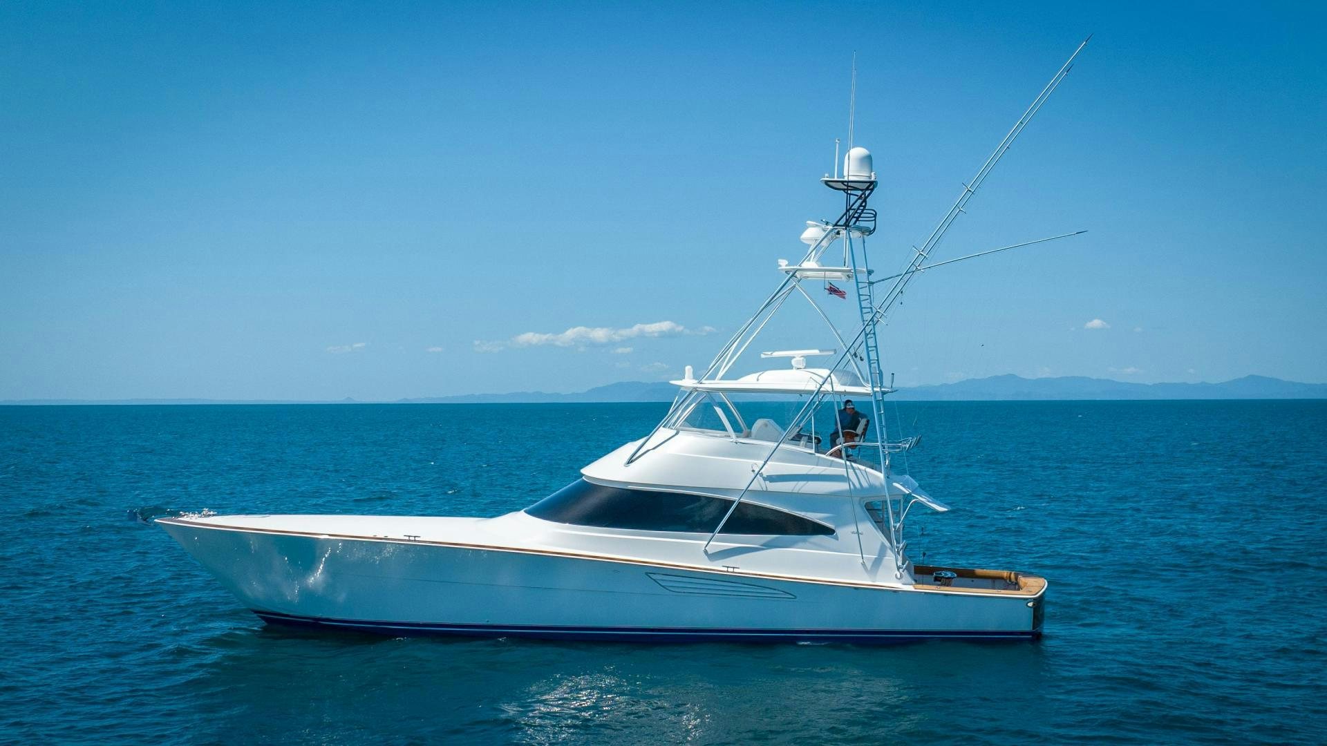 a white boat in the water aboard RAGIN CAJUN Yacht for Sale
