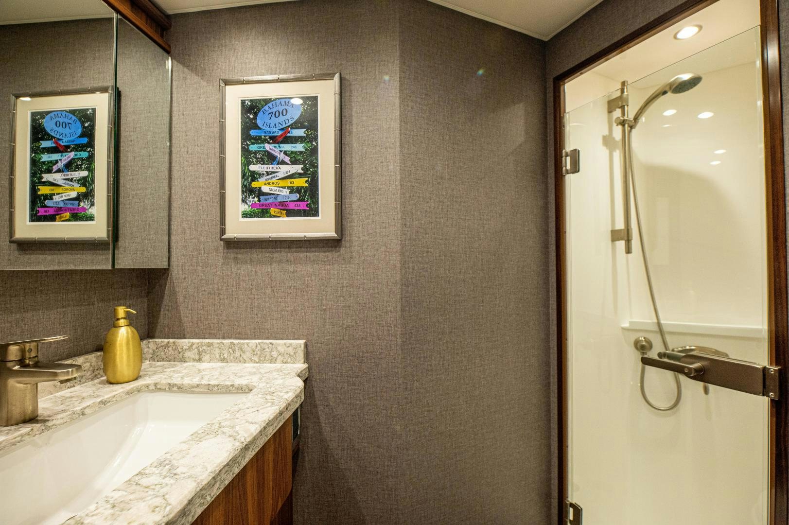 a bathroom with a glass shower door aboard RAGIN CAJUN Yacht for Sale