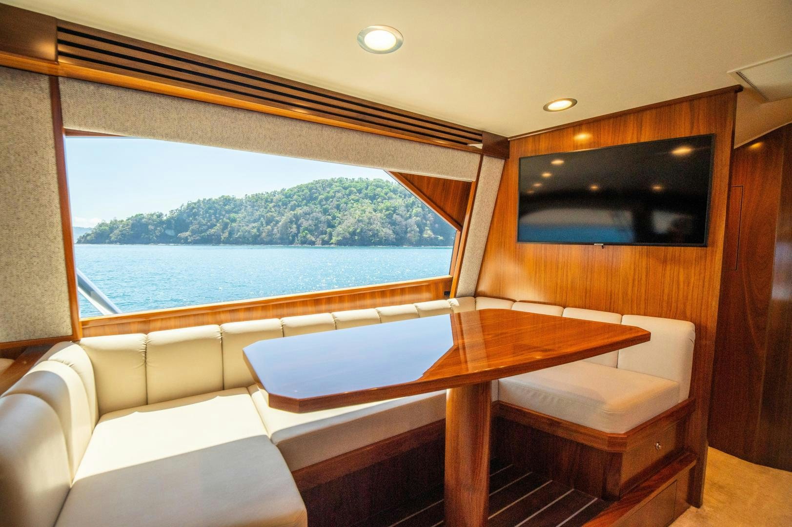 a room with a table and a tv aboard RAGIN CAJUN Yacht for Sale
