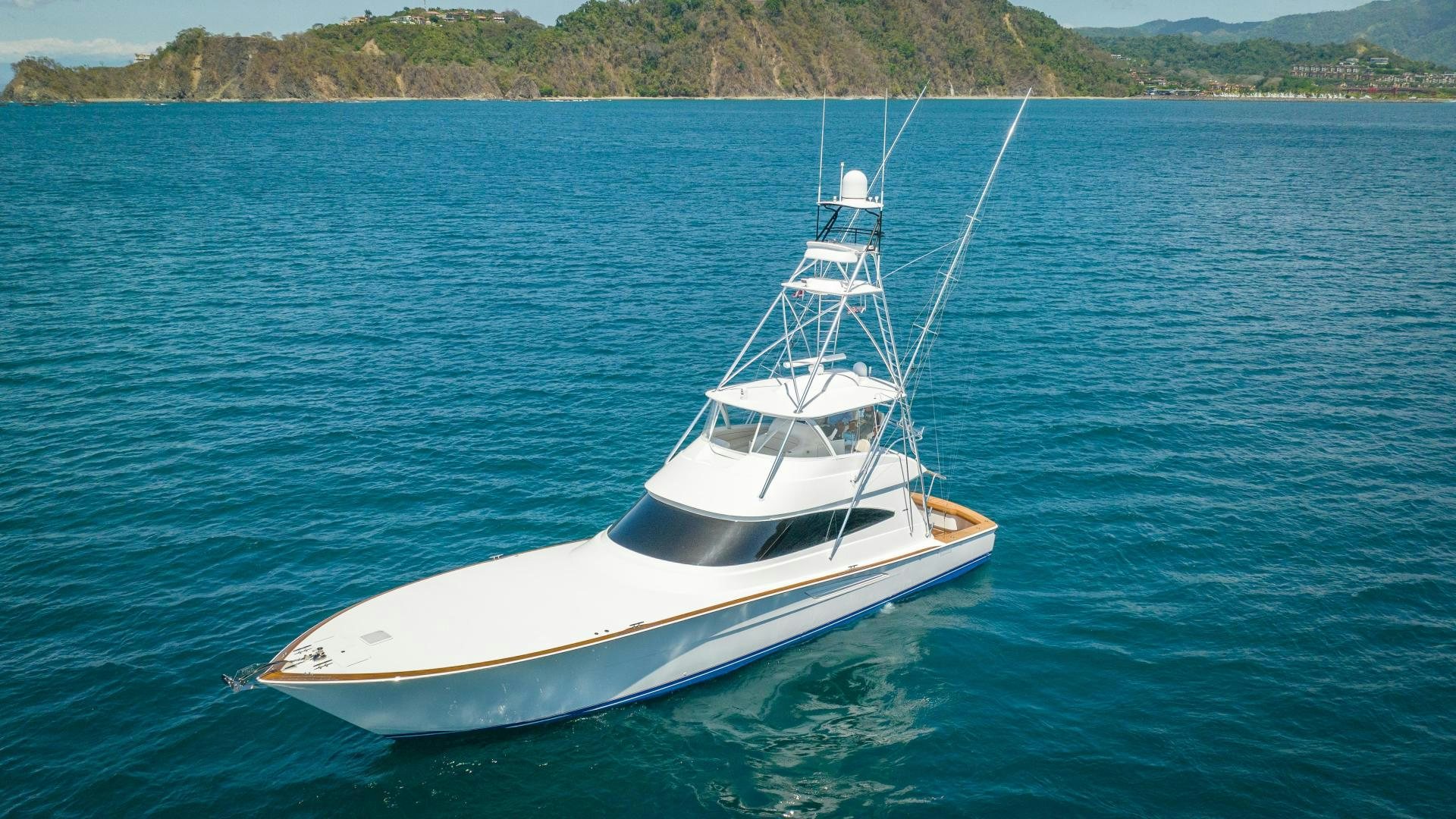 a white boat in the water aboard RAGIN CAJUN Yacht for Sale
