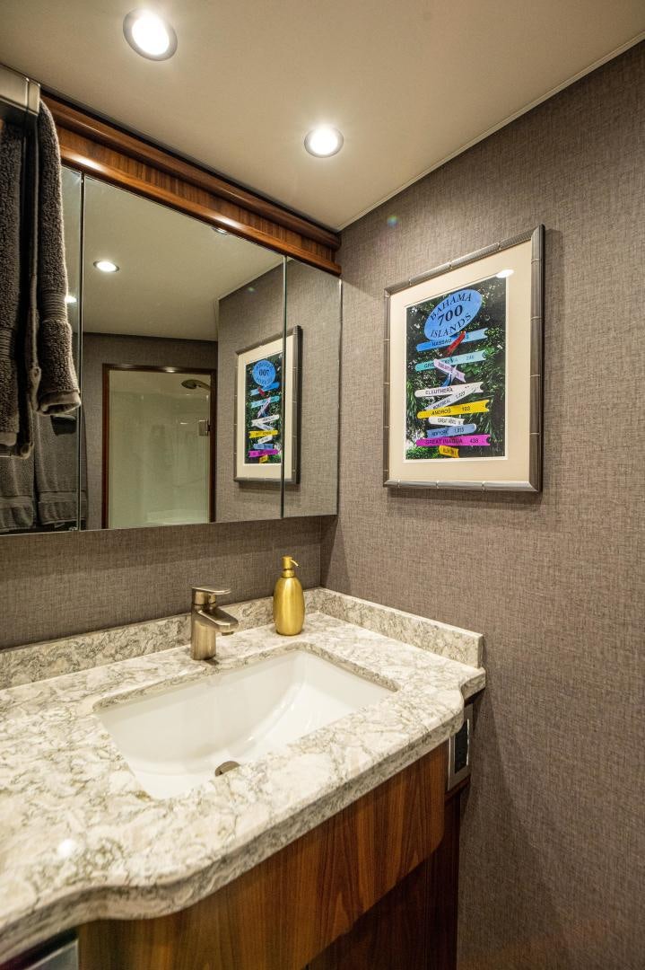 a bathroom with a sink and a mirror aboard RAGIN CAJUN Yacht for Sale
