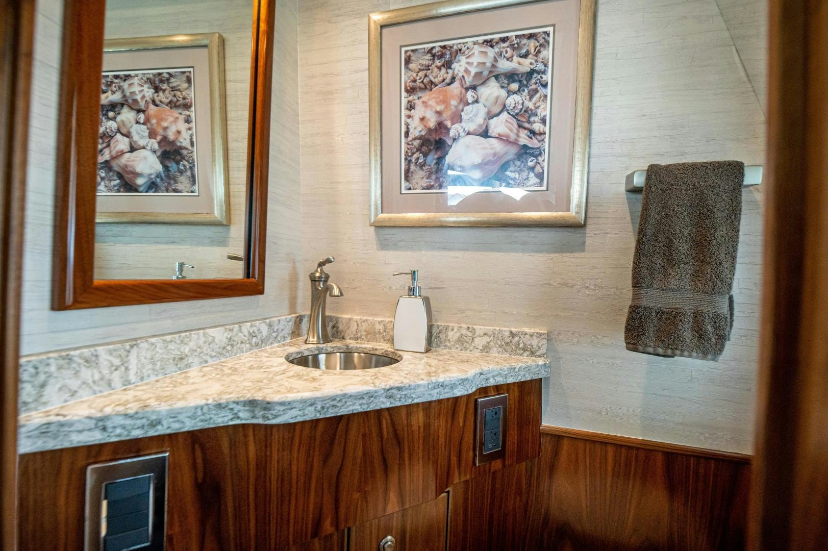 a bathroom with a sink and towels aboard RAGIN CAJUN Yacht for Sale