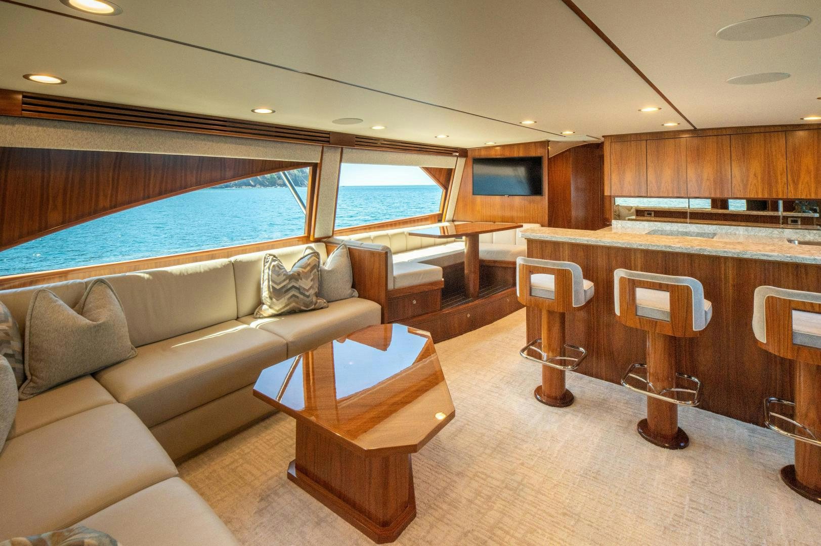 a living room with a couch and a table aboard RAGIN CAJUN Yacht for Sale