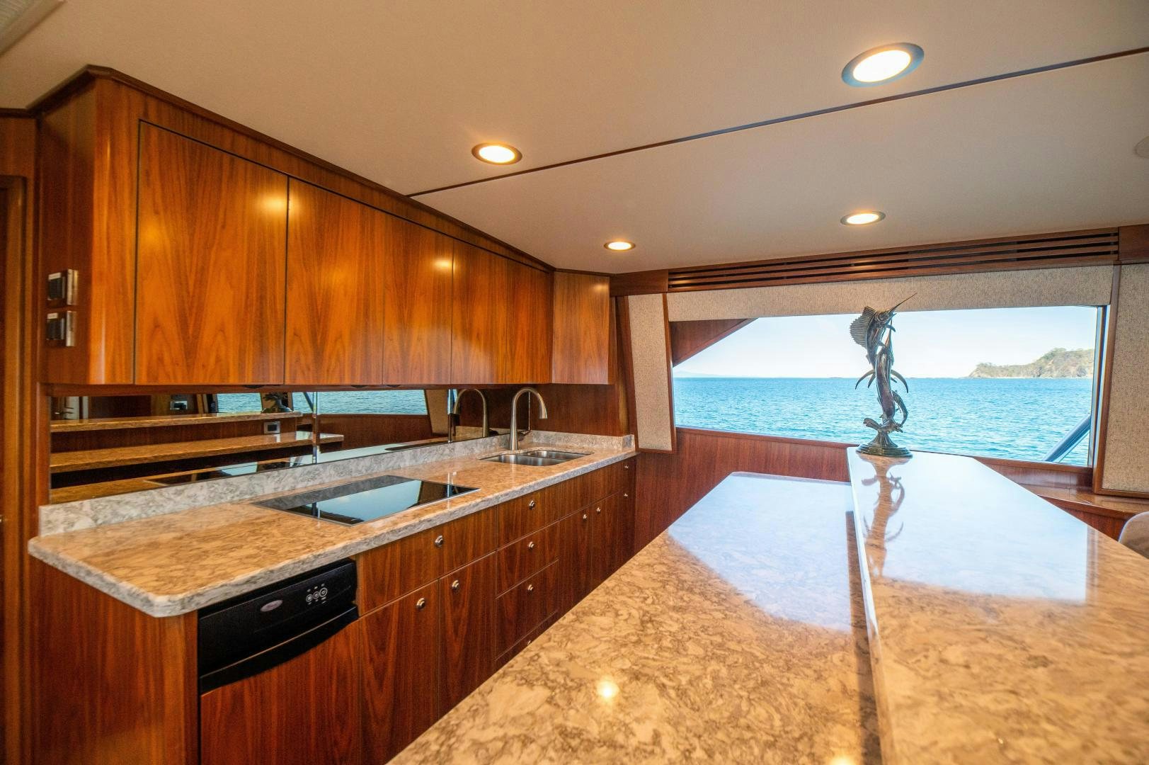 a kitchen with a large island aboard RAGIN CAJUN Yacht for Sale