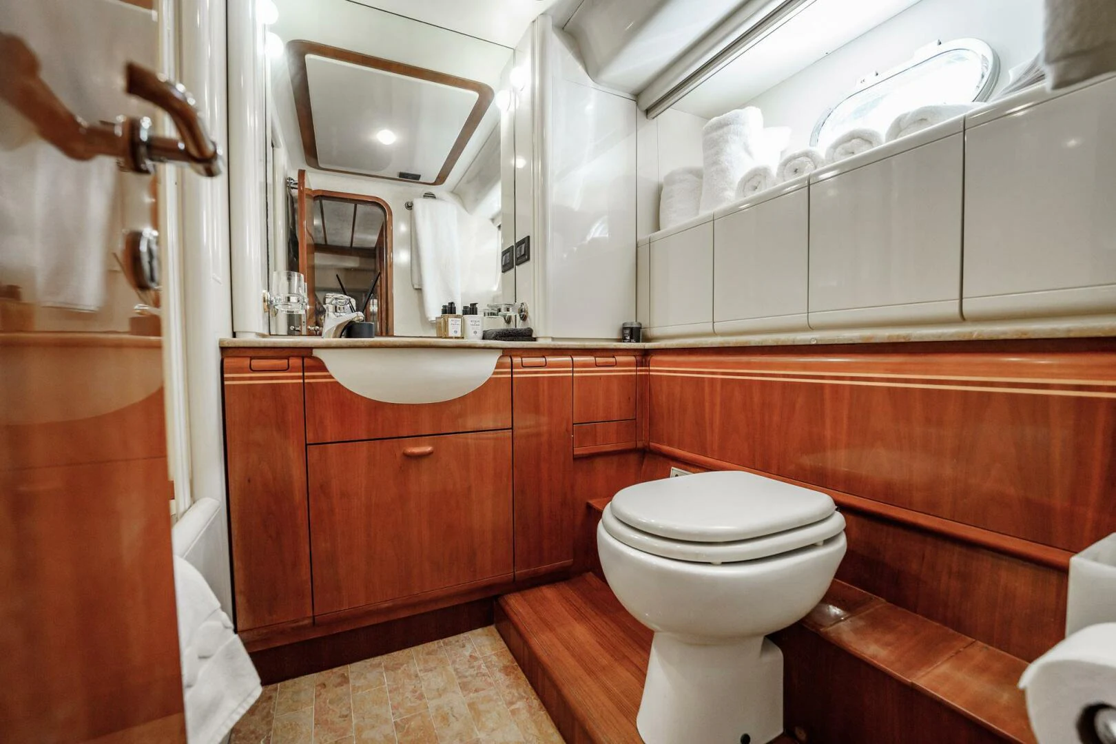 a bathroom with a toilet and a mirror aboard RABBIT Yacht for Sale