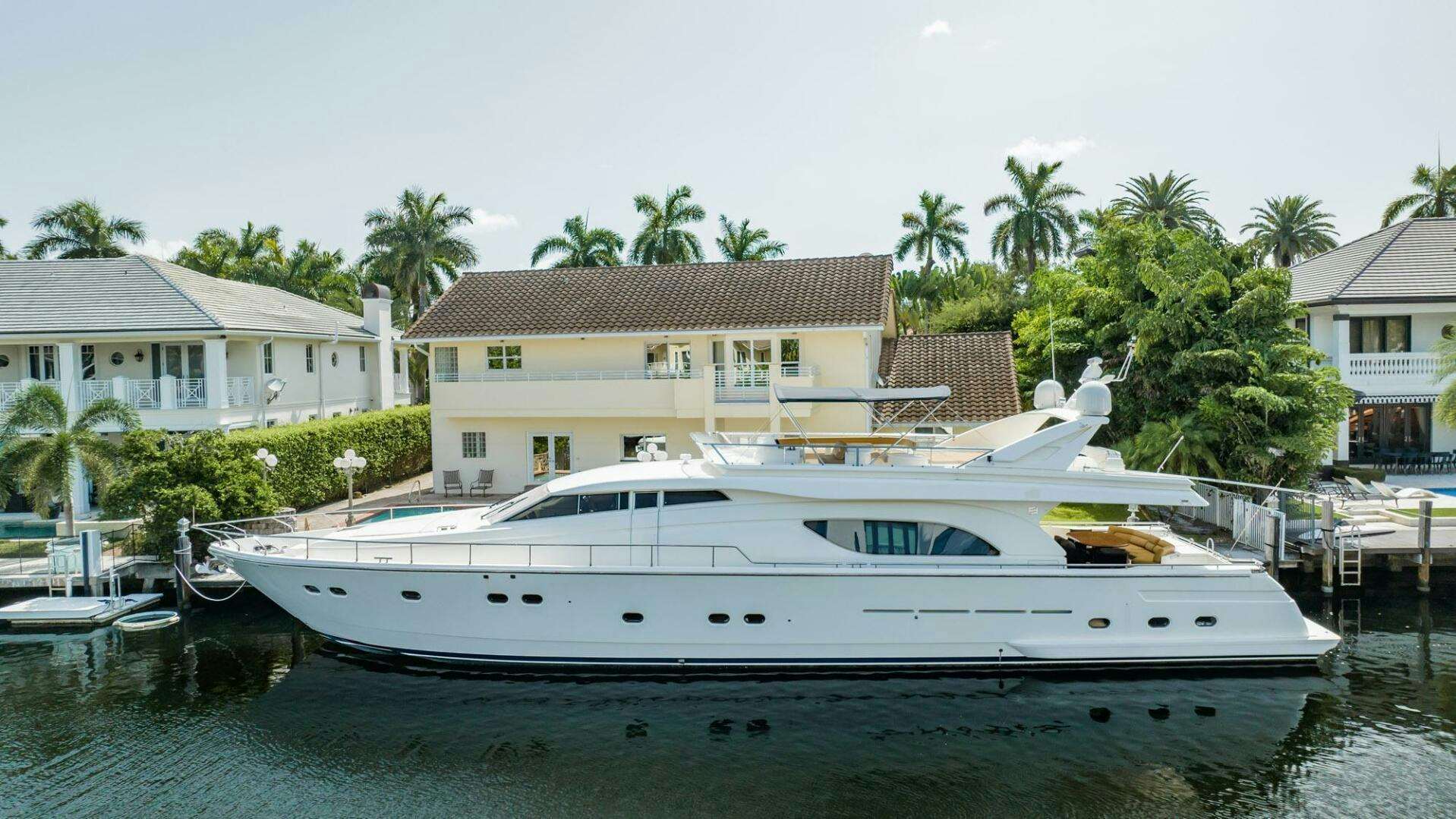 a white boat in a harbor aboard RABBIT Yacht for Sale