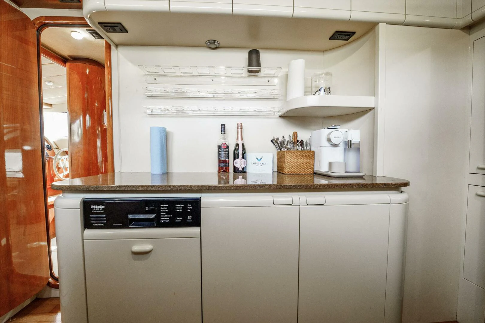 a kitchen with a white refrigerator aboard RABBIT Yacht for Sale