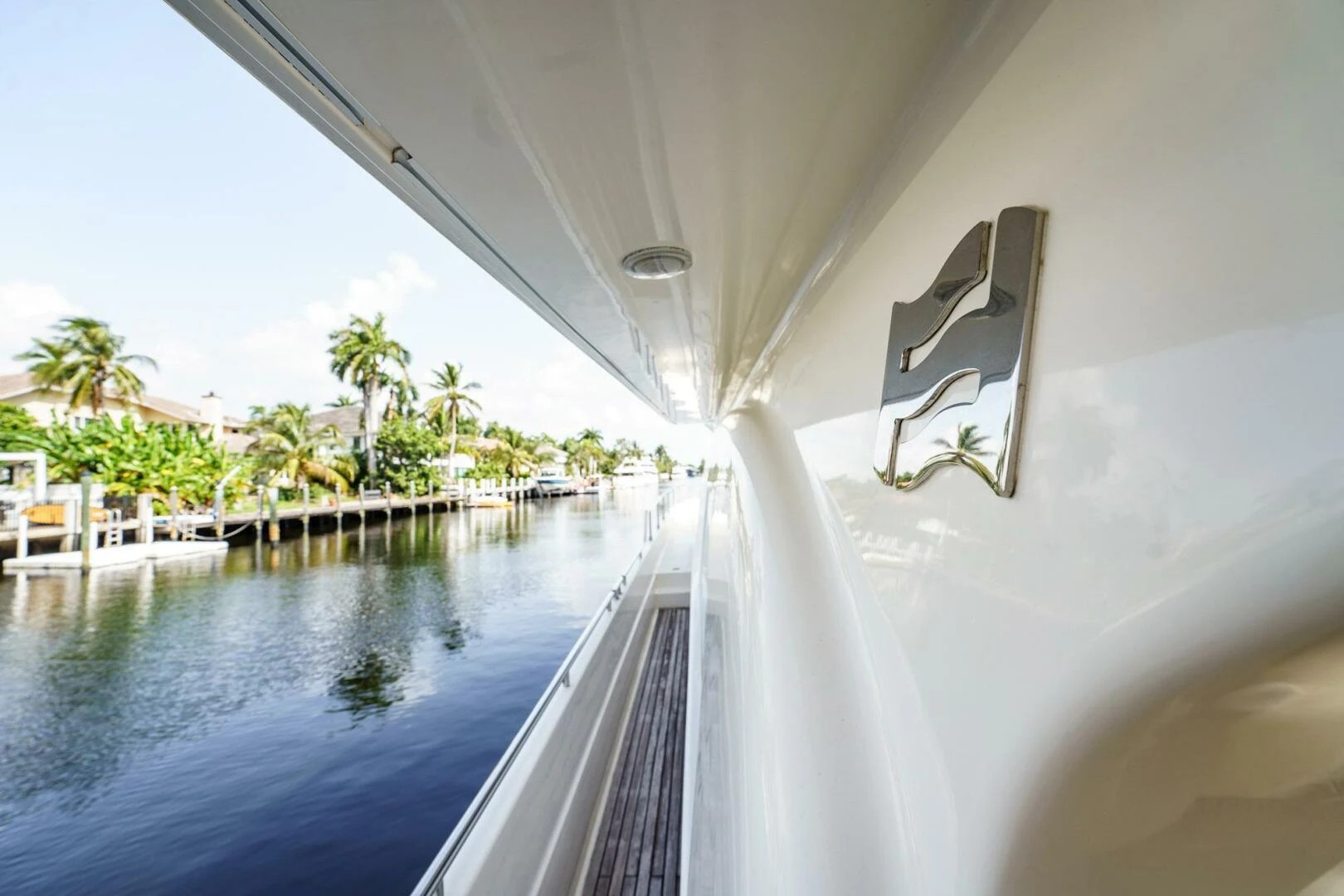 a pool with a large white building and trees around it aboard RABBIT Yacht for Sale