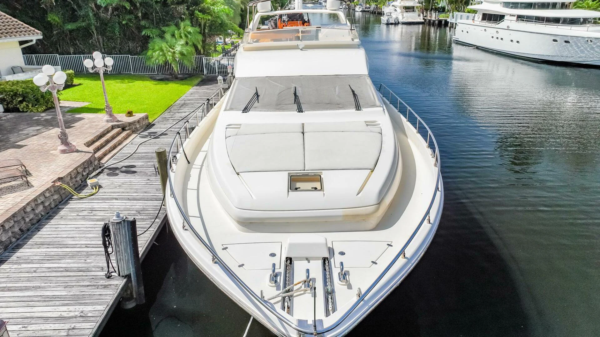 a white boat docked at a pier aboard RABBIT Yacht for Sale