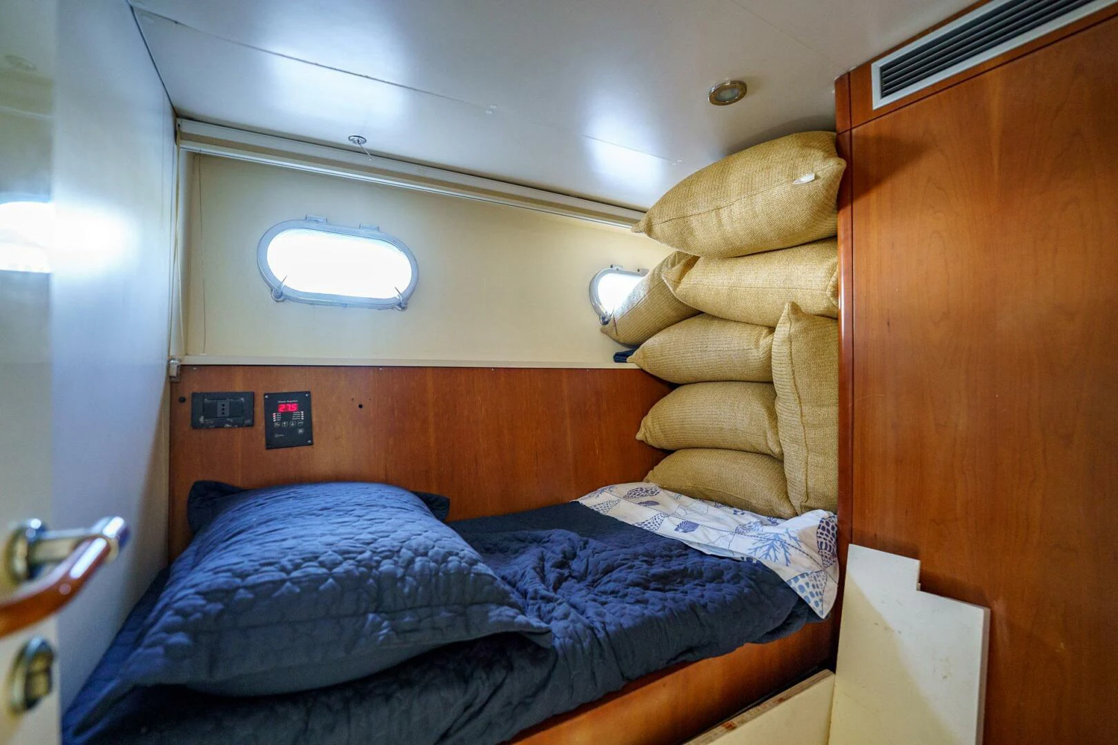 a bed with a stuffed animal on the side aboard RABBIT Yacht for Sale