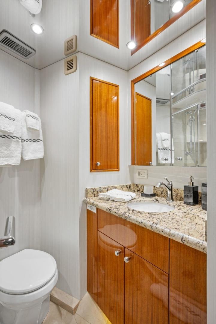 a bathroom with a mirror and a sink aboard FLYNN'S FOLLY III Yacht for Sale